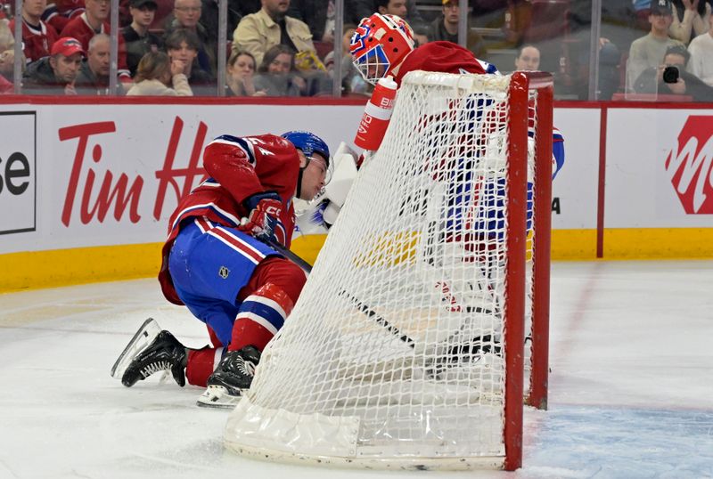 Feb 11, 2024; Montreal, Quebec, CAN; Montreal Canadiens goalie Jake Allen (34) tends to injured teammate defenseman Jordan Harris (54) after he was hit by a St.Louis Blues player during the first period at the Bell Centre. Mandatory Credit: Eric Bolte-USA TODAY Sports