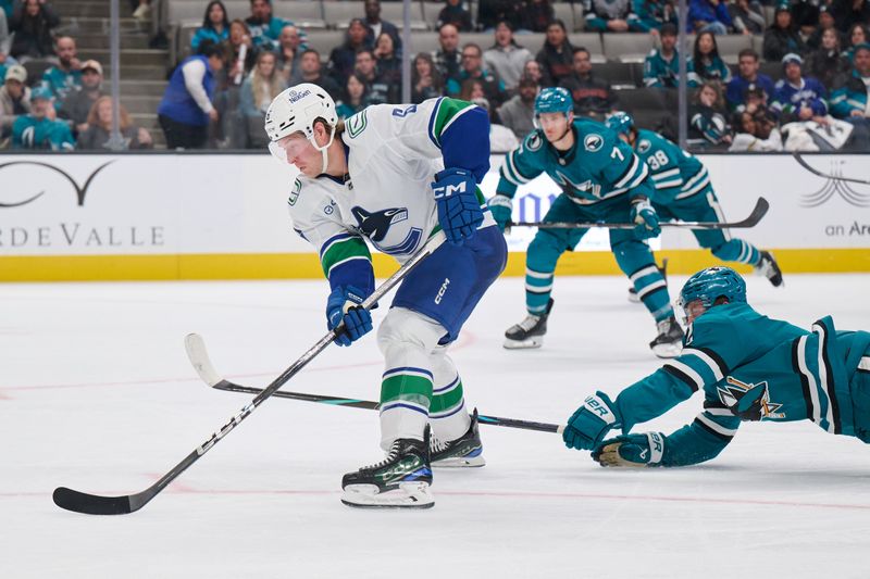 Nov 2, 2024; San Jose, California, USA; San Jose Sharks center Will Smith (2) extends for the puck against Vancouver Canucks right wing Brock Boeser (6) during the third period at SAP Center at San Jose. Mandatory Credit: Robert Edwards-Imagn Images