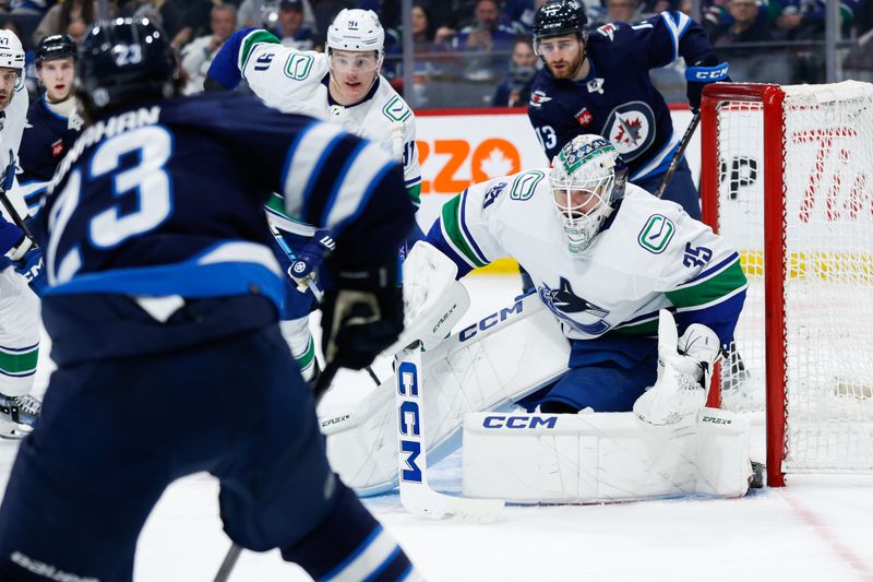 Apr 18, 2024; Winnipeg, Manitoba, CAN;  Vancouver Canucks goalie Thatcher Demko (35) watches Winnipeg Jets forward Sean Monahan (23) during the second period at Canada Life Centre. Mandatory Credit: Terrence Lee-USA TODAY Sports