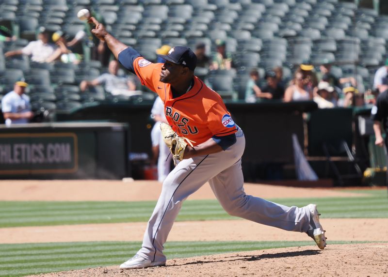 Jul 23, 2023; Oakland, California, USA; Houston Astros relief pitcher Hector Neris (50) pitches the ball against the Oakland Athletics during the eighth inning at Oakland-Alameda County Coliseum. Mandatory Credit: Kelley L Cox-USA TODAY Sports