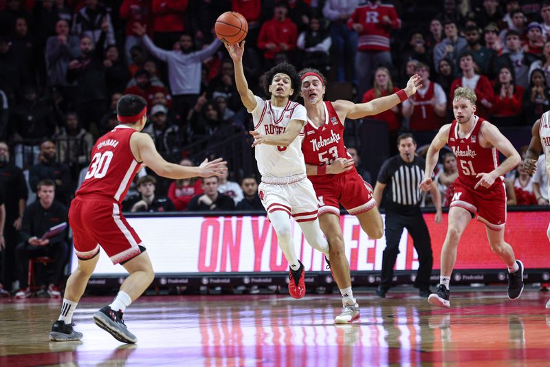 Jan 17, 2024; Piscataway, New Jersey, USA; Rutgers Scarlet Knights guard Derek Simpson (0) is fouled by Nebraska Cornhuskers forward Josiah Allick (53) in front of guard Keisei Tominaga (30) and forward Rienk Mast (51)  during the second half at Jersey Mike's Arena. Mandatory Credit: Vincent Carchietta-USA TODAY Sports