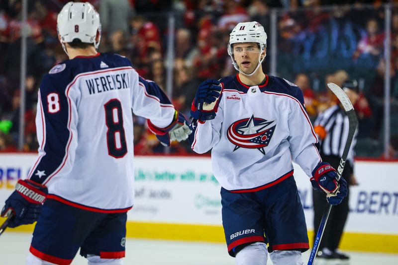 Jan 25, 2024; Calgary, Alberta, CAN; Columbus Blue Jackets center Adam Fantilli (11) celebrates his goal with teammates against the Calgary Flames during the third period at Scotiabank Saddledome. Mandatory Credit: Sergei Belski-USA TODAY Sports