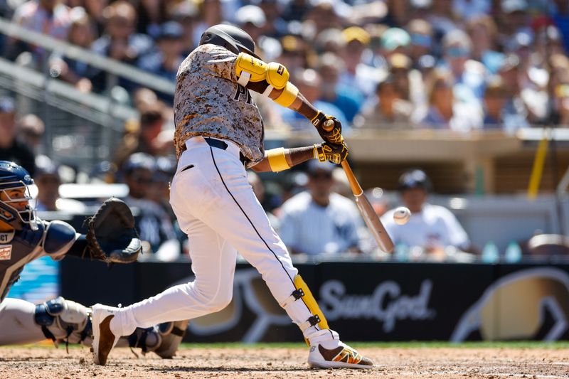 May 26, 2024; San Diego, California, USA;  San Diego Padres first baseman Luis Arraez (4) hits a rbi single in the sixth inning against the New York Yankees at Petco Park. Mandatory Credit: David Frerker-USA TODAY Sports