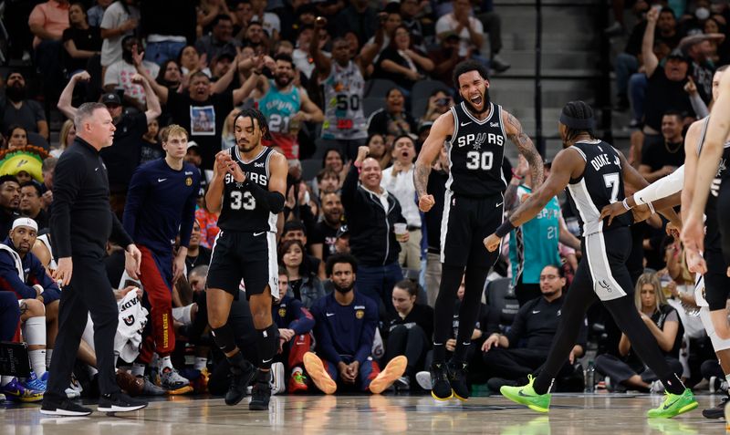 SAN ANTONIO, TX - APRIL 12: Julian Champagne #30 of the San Antonio Spurs celebrates after a basket against the Denver Nuggets in the second half at Frost Bank Center on April 12, 2024 in San Antonio, Texas. NOTE TO USER: User expressly acknowledges and agrees that, by downloading and or using this photograph, User is consenting to terms and conditions of the Getty Images License Agreement. (Photo by Ronald Cortes/Getty Images)