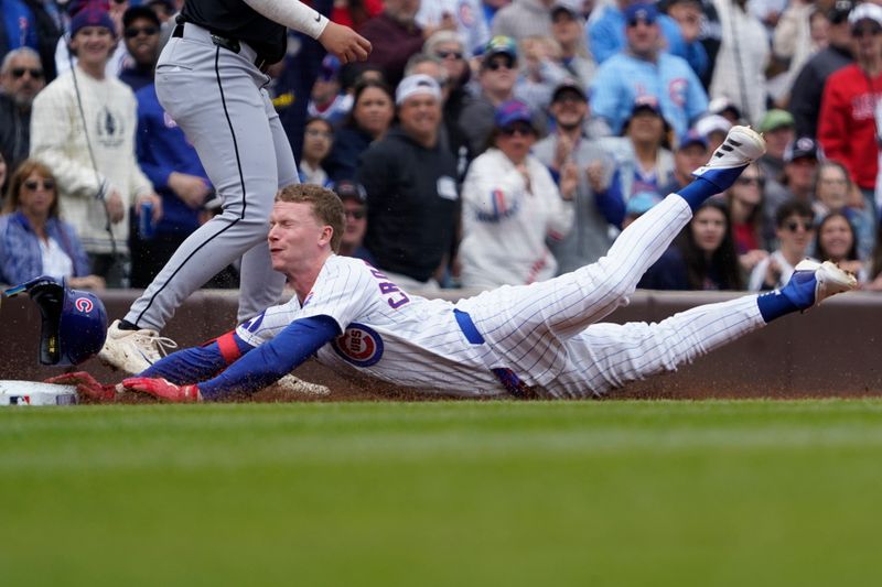 May 18, 2025; Chicago, Illinois, USA; Chicago Cubs outfielder Pete Crow-Armstrong (4) dives into third base with a triple against the Chicago White Sox during the first inning at Wrigley Field. Mandatory Credit: David Banks-Imagn Images