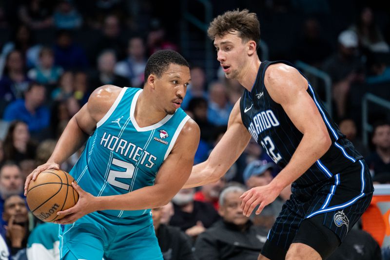 CHARLOTTE, NORTH CAROLINA - APRIL 05: Franz Wagner #22 of the Orlando Magic guards Grant Williams #2 of the Charlotte Hornets in the fourth quarter during their game at Spectrum Center on April 05, 2024 in Charlotte, North Carolina. NOTE TO USER: User expressly acknowledges and agrees that, by downloading and or using this photograph, User is consenting to the terms and conditions of the Getty Images License Agreement. (Photo by Jacob Kupferman/Getty Images)