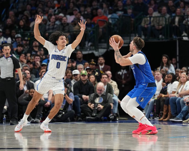 DALLAS, TX - JANUARY 29: Anthony Black #0 of the Orlando Magic plays defense during the game  against Luka Doncic #77 of the Dallas Mavericks on January 29, 2024 at the American Airlines Center in Dallas, Texas. NOTE TO USER: User expressly acknowledges and agrees that, by downloading and or using this photograph, User is consenting to the terms and conditions of the Getty Images License Agreement. Mandatory Copyright Notice: Copyright 2024 NBAE (Photo by Glenn James/NBAE via Getty Images)