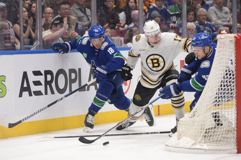 Feb 24, 2024; Vancouver, British Columbia, CAN;  Boston Bruins forward Charlie Coyle (13) battles for the puck against Vancouver Canucks forward Sam Lafferty (18) and forward Teddy Blueger (53) during the third period at Rogers Arena. Mandatory Credit: Anne-Marie Sorvin-USA TODAY Sports