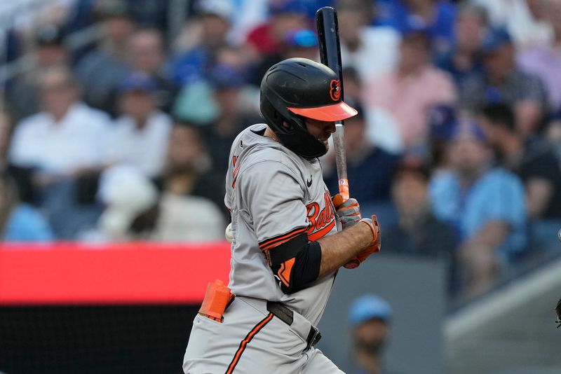 Jun 4, 2024; Toronto, Ontario, CAN; Baltimore Orioles center fielder Colton Cowser (17) gets hit in the back by a pitch from Toronto Blue Jays pitcher Genesis Cabrera (not pictured) during the third inning at Rogers Centre. Mandatory Credit: John E. Sokolowski-USA TODAY Sports