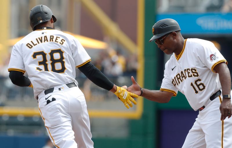 Apr 9, 2024; Pittsburgh, Pennsylvania, USA;  Pittsburgh Pirates right fielder Edward Olivares (38) celebrates with first base coach Tarrik Brock (16) after hitting his second solo home run of the game against the Detroit Tigers during the sixth inning at PNC Park. Mandatory Credit: Charles LeClaire-USA TODAY Sports