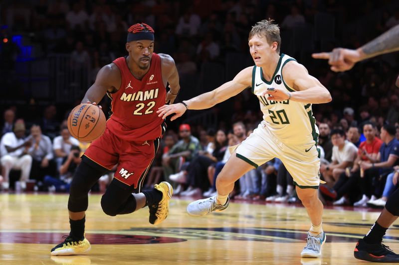 MIAMI, FLORIDA - NOVEMBER 26: Jimmy Butler #22 of the Miami Heat drives past AJ Green #20 of the Milwaukee Bucks during the fourth quarter of the Emirates NBA Cup at Kaseya Center on November 26, 2024 in Miami, Florida. NOTE TO USER: User expressly acknowledges and agrees that, by downloading and or using this photograph, User is consenting to the terms and conditions of the Getty Images License Agreement. (Photo by Megan Briggs/Getty Images)