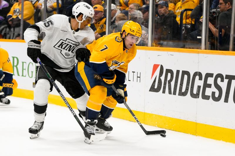 Nov 4, 2024; Nashville, Tennessee, USA;  Nashville Predators defenseman Marc Del Gaizo (7) clears the puck as Los Angeles Kings center Alex Turcotte (15) defends during the second period at Bridgestone Arena. Mandatory Credit: Steve Roberts-Imagn Images