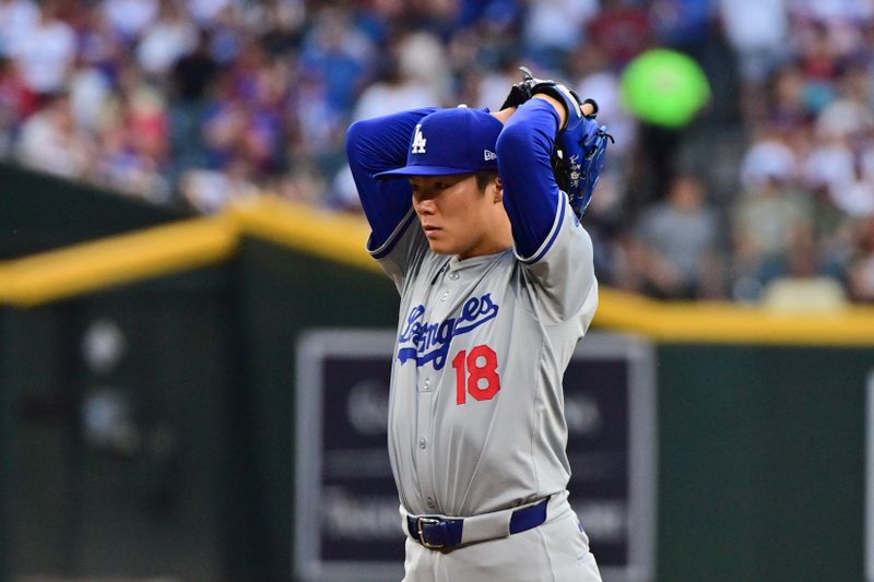 May 1, 2024; Phoenix, Arizona, USA;  Los Angeles Dodgers pitcher Yoshinobu Yamamoto (18) warms up in the first inning against the Arizona Diamondbacks at Chase Field. Mandatory Credit: Matt Kartozian-USA TODAY Sports