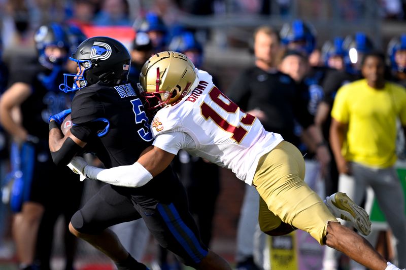 Nov 16, 2024; Dallas, Texas, USA; SMU Mustangs wide receiver Moochie Dixon (5) catches a pass as Boston College Eagles cornerback Bryquice Brown (19) defends during the first half at the Gerald J. Ford Stadium. Mandatory Credit: Jerome Miron-Imagn Images