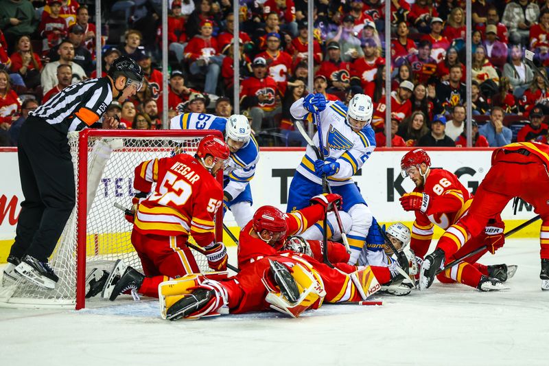 Oct 11, 2025; Calgary, Alberta, CAN; Calgary Flames goaltender Dustin Wolf (32) makes a save against the St. Louis Blues during the third period at Scotiabank Saddledome. Mandatory Credit: Sergei Belski-Imagn Images