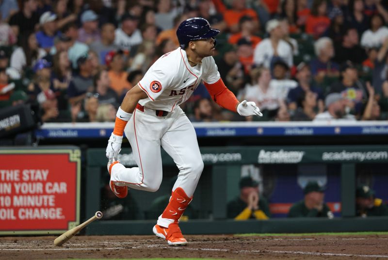 May 27, 2025; Houston, Texas, USA ; Houston Astros right fielder Cam Smith (11) hits a two-RBI double against the Athletics in the third inning at Daikin Park. Mandatory Credit: Thomas Shea-Imagn Images