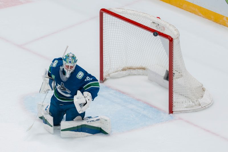 Mar 18, 2025; Vancouver, British Columbia, CAN; The puck hits the cross bar behind Vancouver Canucks goalie Kevin Lankinen (32) against the Winnipeg Jets in the second period at Rogers Arena. Mandatory Credit: Bob Frid-Imagn Images