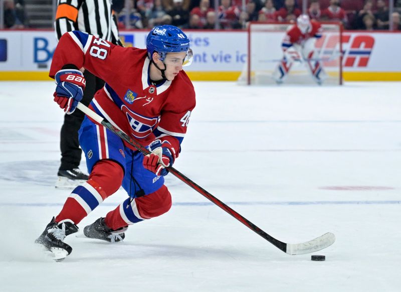 Oct 26, 2024; Montreal, Quebec, CAN; Montreal Canadiens defenseman Lane Hutson (48) plays the puck against the St.Louis Blues during the first period at the Bell Centre. Mandatory Credit: Eric Bolte-Imagn Images