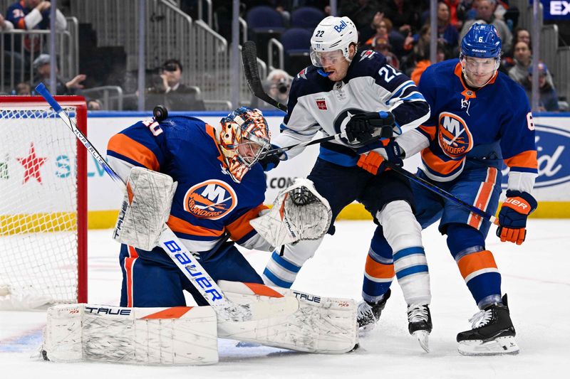 Mar 23, 2024; Elmont, New York, USA;  New York Islanders goaltender Semyon Varlamov (40) makes a save in front of Winnipeg Jets center Mason Appleton (22) and New York Islanders defenseman Ryan Pulock (6) during the first period at UBS Arena. Mandatory Credit: Dennis Schneidler-USA TODAY Sports