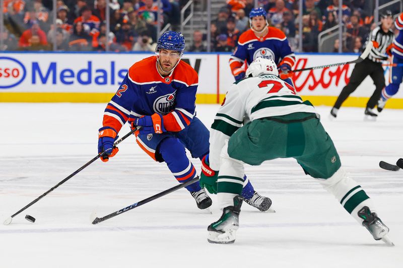 Nov 21, 2024; Edmonton, Alberta, CAN; Edmonton Oilers defensemen Evan Bouchard (2) looks to carry the puck around Minnesota Wild defensemen Jonas Brodin (25) during the first period at Rogers Place. Mandatory Credit: Perry Nelson-Imagn Images