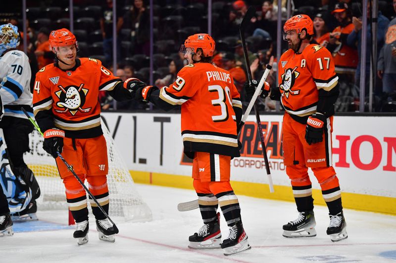 Sep 22, 2025; Anaheim, California, USA; Anaheim Ducks right wing Matthew Phillips (39) celebrates his goal scored against the Utah Mammoth with center Mikael Granlund (64) and left wing Alex Killorn (17) with during the second period at Honda Center. Mandatory Credit: Gary A. Vasquez-Imagn Images