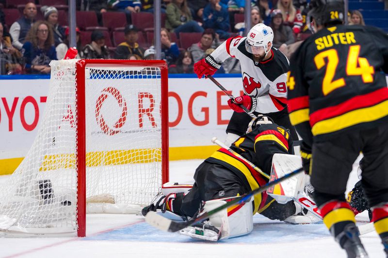 Oct 30, 2024; Vancouver, British Columbia, CAN; New Jersey Devils forward Tomas Tatar (90) scores on Vancouver Canucks goalie Arturs Silovs (31) during the third period at Rogers Arena. Mandatory Credit: Bob Frid-Imagn Images