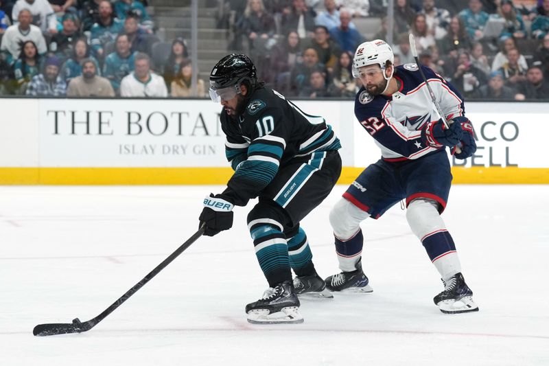 Feb 17, 2024; San Jose, California, USA; San Jose Sharks left wing Anthony Duclair (10) skates with the puck against Columbus Blue Jackets right wing Emil Bemstrom (52) during the second period at SAP Center at San Jose. Mandatory Credit: Darren Yamashita-USA TODAY Sports