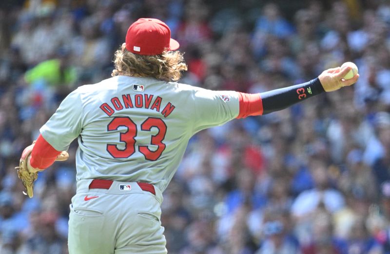 May 12, 2024; Milwaukee, Wisconsin, USA; St. Louis Cardinals outfielder Brendan Donovan (33) makes the throw to first base against the Milwaukee Brewers in the fourth inning at American Family Field. Mandatory Credit: Michael McLoone-USA TODAY Sports