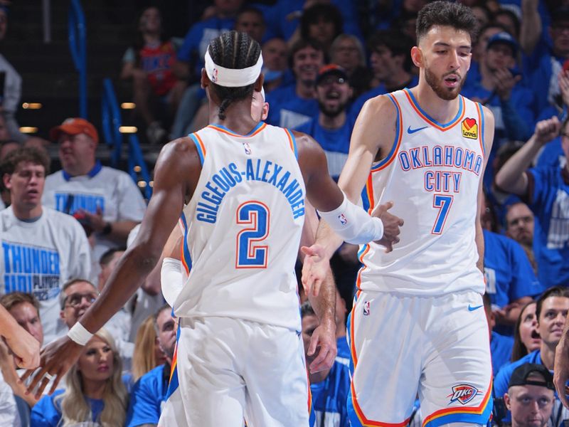 OKLAHOMA CITY, OK - MAY 13:  Shai Gilgeous-Alexander #2 and Chet Holmgren #7 of the Oklahoma City Thunder high five during the game  against the Denver Nuggets during Round 2 Game 5 of the 2025 NBA Playoffs on May 13, 2025 at Paycom Center in Oklahoma City, Oklahoma. NOTE TO USER: User expressly acknowledges and agrees that, by downloading and or using this photograph, User is consenting to the terms and conditions of the Getty Images License Agreement. Mandatory Copyright Notice: Copyright 2025 NBAE (Photo by Garrett Ellwood/NBAE via Getty Images)
