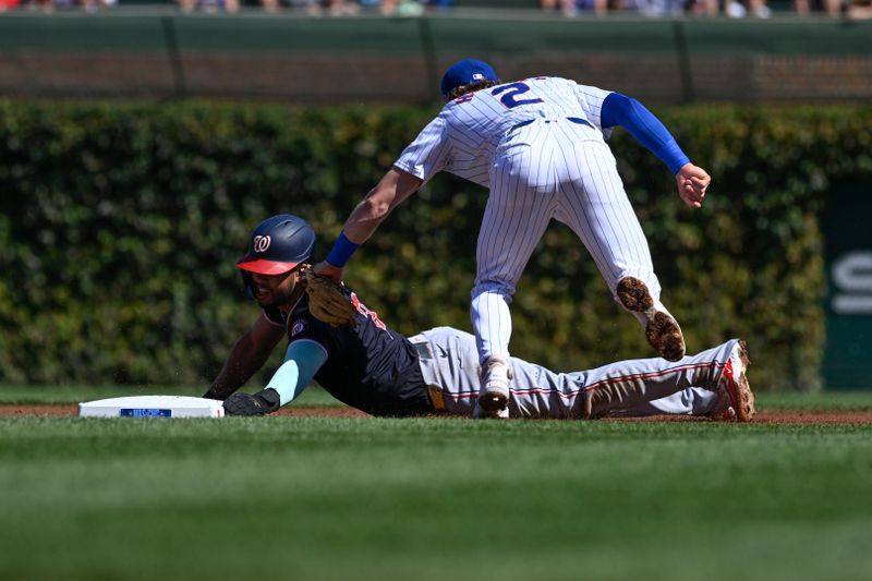 Sep 21, 2024; Chicago, Illinois, USA;  Chicago Cubs second baseman Nico Hoerner (2) tags out Washington Nationals second baseman Luis García Jr. (2) on an attempted steal during the first inning at Wrigley Field. Mandatory Credit: Matt Marton-Imagn Images