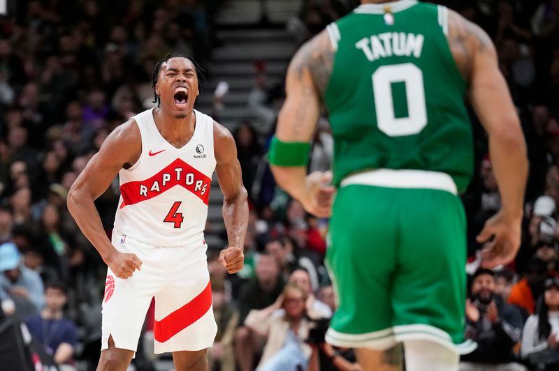 TORONTO, ON - OCTOBER 15: Scottie Barnes #4 of the Toronto Raptors celebrates behind Jayson Tatum #0 of the Boston Celtics during the second half of their preseason basketball game at the Scotiabank Arena on October 15, 2024 in Toronto, Ontario, Canada. NOTE TO USER: User expressly acknowledges and agrees that, by downloading and/or using this Photograph, user is consenting to the terms and conditions of the Getty Images License Agreement. (Photo by Mark Blinch/Getty Images)