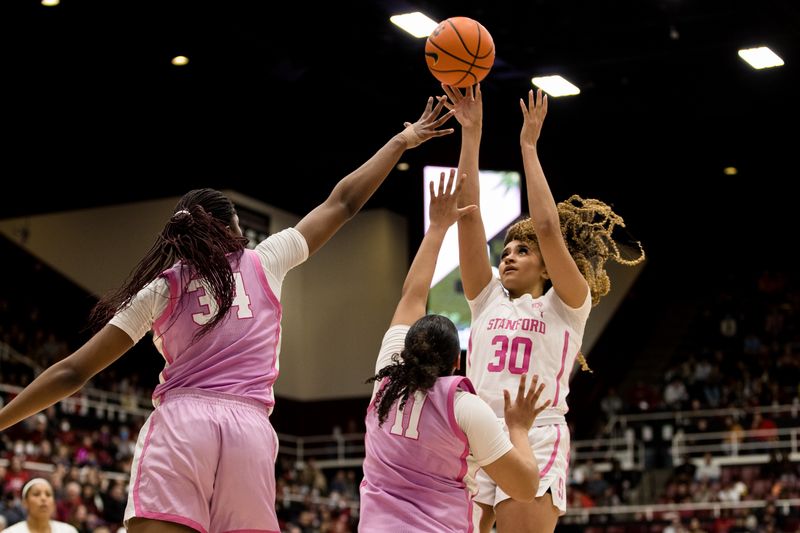 Feb 17, 2023; Stanford, California, USA;  Stanford Cardinal guard Haley Jones (30) shoots over USC Trojans center Clarice Akunwafo (34) and guard Destiny Littleton (11) during the second half at Maples Pavilion. Mandatory Credit: John Hefti-USA TODAY Sports