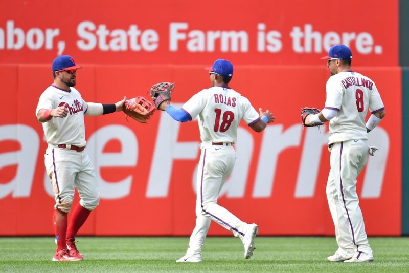 Aug 6, 2023; Philadelphia, Pennsylvania, USA; Philadelphia Phillies left fielder Kyle Schwarber (12), center fielder Johan Rojas (18) and right fielder Nick Castellanos (8) celebrate win against the Kansas City Royals at Citizens Bank Park. Mandatory Credit: Eric Hartline-USA TODAY Sports