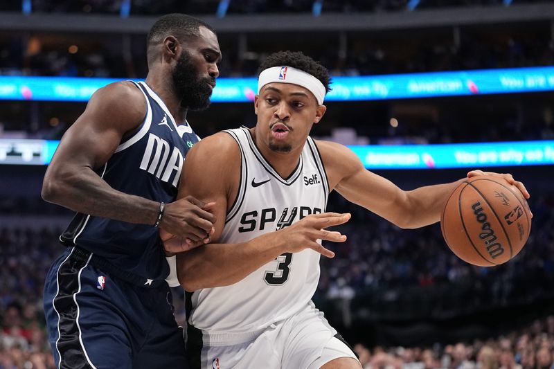 DALLAS, TEXAS - DECEMBER 23: Keldon Johnson #3 of the San Antonio Spurs controls the ball as Tim Hardaway Jr. #10 of the Dallas Mavericks defends during the first half at American Airlines Center on December 23, 2023 in Dallas, Texas. NOTE TO USER: User expressly acknowledges and agrees that, by downloading and or using this photograph, User is consenting to the terms and conditions of the Getty Images License Agreement.  (Photo by Sam Hodde/Getty Images)