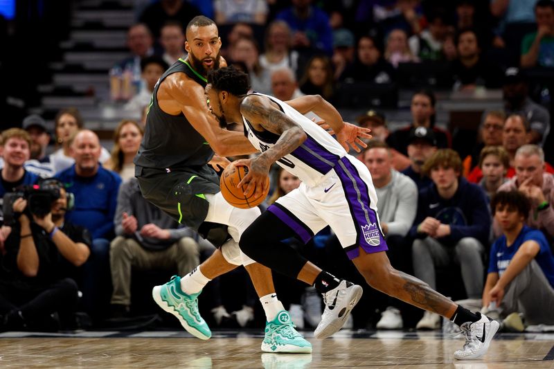 MINNEAPOLIS, MINNESOTA - MARCH 01: Malik Monk #0 of the Sacramento Kings drives to the basket against Rudy Gobert #27 of the Minnesota Timberwolves during overtime at Target Center on March 01, 2024 in Minneapolis, Minnesota. The Kings defeated the Timberwolves 124-120 in overtime. NOTE TO USER: User expressly acknowledges and agrees that, by downloading and or using this photograph, User is consenting to the terms and conditions of the Getty Images License Agreement. (Photo by David Berding/Getty Images)