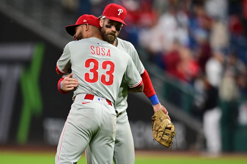 May 10, 2025; Cleveland, Ohio, USA; Philadelphia Phillies third baseman Edmundo Sosa (33) celebrates with first baseman Bryce Harper (3) after the Phillies beat the Cleveland Guardians at Progressive Field. Mandatory Credit: Ken Blaze-Imagn Images