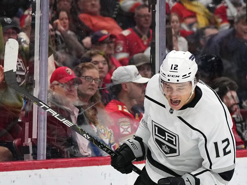 Jan 11, 2024; Sunrise, Florida, USA; Los Angeles Kings left wing Trevor Moore (12) celebrates his goal against the Florida Panthers during the first period at Amerant Bank Arena. Mandatory Credit: Jasen Vinlove-USA TODAY Sports