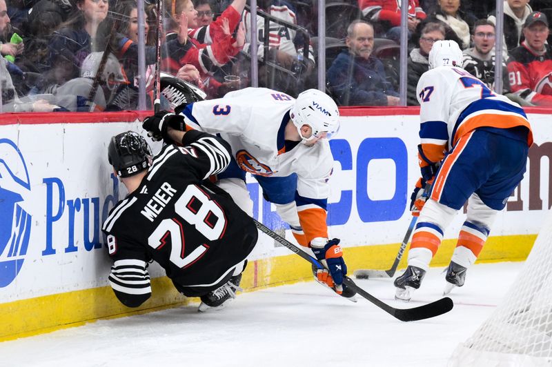 Feb 5, 2026; Newark, New Jersey, USA; New York Islanders defenseman Adam Pelech (3) checks New Jersey Devils right wing Timo Meier (28) during the second period at Prudential Center. Mandatory Credit: John Jones-Imagn Images