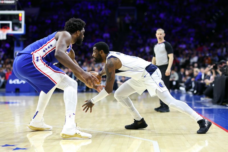 PHILADELPHIA, PENNSYLVANIA - MARCH 29: Kyrie Irving #2 of the Dallas Mavericks drives past Joel Embiid #21 of the Philadelphia 76ers during the third quarter at Wells Fargo Center on March 29, 2023 in Philadelphia, Pennsylvania. NOTE TO USER: User expressly acknowledges and agrees that, by downloading and or using this photograph, User is consenting to the terms and conditions of the Getty Images License Agreement. (Photo by Tim Nwachukwu/Getty Images)