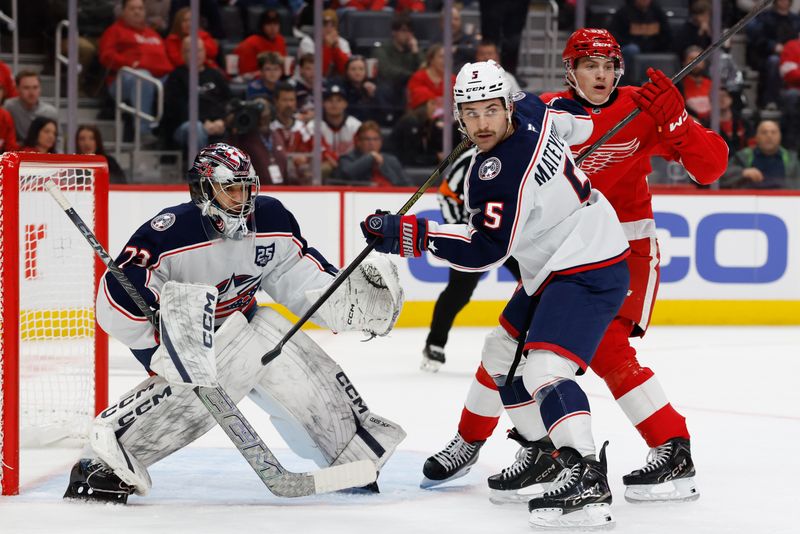 Nov 22, 2025; Detroit, Michigan, USA;  Columbus Blue Jackets defenseman Denton Mateychuk (5) and Detroit Red Wings center Emmitt Finnie (58) fight for position in front of goaltender Jet Greaves (73) in the second period at Little Caesars Arena. Mandatory Credit: Rick Osentoski-Imagn Images
