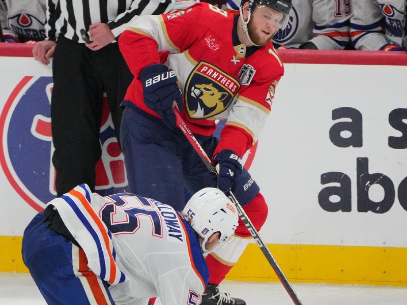 Jun 10, 2024; Sunrise, Florida, USA; Edmonton Oilers forward Dylan Holloway (55) defends against Florida Panthers forward Matthew Tkachuk (19) during the second period in game two of the 2024 Stanley Cup Final at Amerant Bank Arena. Mandatory Credit: Jim Rassol-USA TODAY Sports