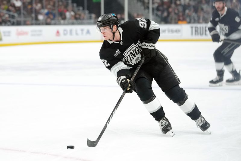 Dec 23, 2025; Los Angeles, California, USA; LA Kings defenseman Brandt Clarke (92) skates with the puck against the Seattle Kraken in the second period at Crypto.com Arena. Mandatory Credit: Kirby Lee-Imagn Images