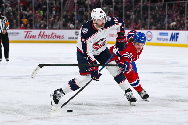 Mar 12, 2024; Montreal, Quebec, CAN; Montreal Canadiens left wing Michael Pezzetta (55) defends the puck against Columbus Blue Jackets defenseman Erik Gudbranson (44) during the second period at Bell Centre. Mandatory Credit: David Kirouac-USA TODAY Sports