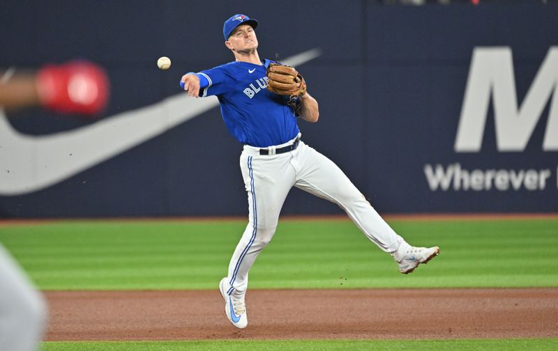 Aug 26, 2023; Toronto, Ontario, CAN;  Toronto Blue Jays third baseman Matt Chapman (26) throws to retire Cleveland Guardians left fielder Oscar Gonzalez (not shown) in the fourth inning at Rogers Centre. Mandatory Credit: Dan Hamilton-USA TODAY Sports