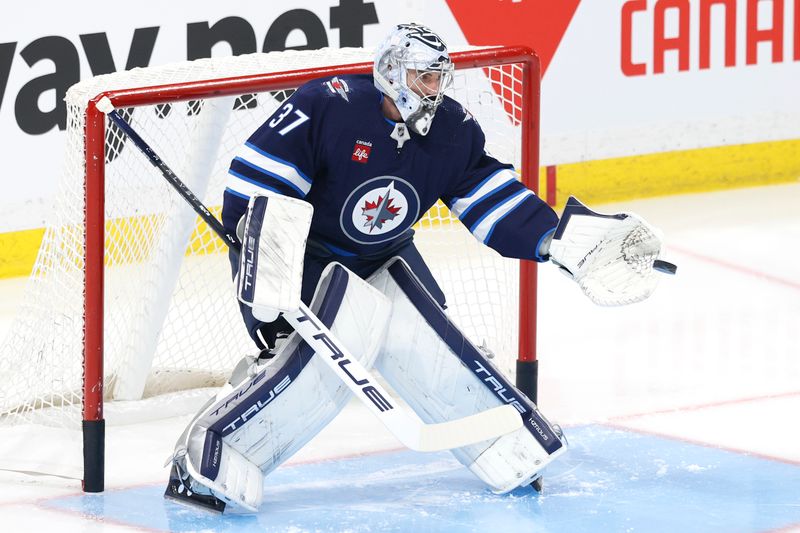 Apr 21, 2024; Winnipeg, Manitoba, CAN; Winnipeg Jets goaltender Connor Hellebuyck (37) warms before a game against the Colorado Avalanche in game one of the first round of the 2024 Stanley Cup Playoffs at Canada Life Centre. Mandatory Credit: James Carey Lauder-USA TODAY Sports