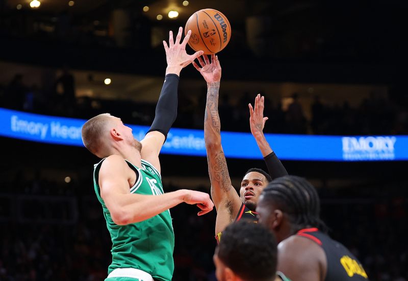 ATLANTA, GEORGIA - MARCH 28:  Dejounte Murray #5 of the Atlanta Hawks shoots a basket against Kristaps Porzingis #8 of the Boston Celtics during overtime at State Farm Arena on March 28, 2024 in Atlanta, Georgia.  NOTE TO USER: User expressly acknowledges and agrees that, by downloading and/or using this photograph, user is consenting to the terms and conditions of the Getty Images License Agreement.  (Photo by Kevin C. Cox/Getty Images)