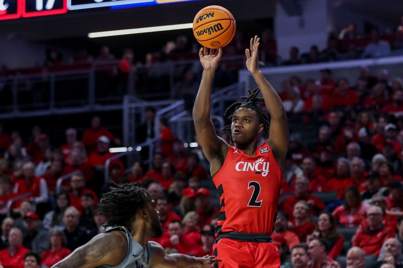 Mar 9, 2024; Cincinnati, Ohio, USA; Cincinnati Bearcats guard Jizzle James (2) shoots against the West Virginia Mountaineers in the first half at Fifth Third Arena. Mandatory Credit: Katie Stratman-USA TODAY Sports