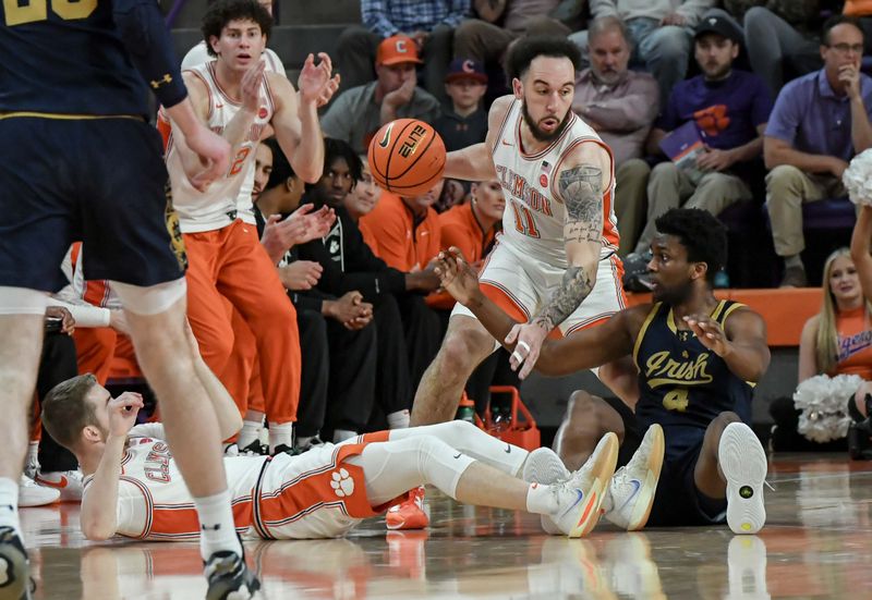 Feb 26, 2025; Clemson, South Carolina, USA; Clemson guard Jaeden Zachery (11) takes a loose ball away from Notre Dame guard Sir Mohammed (4) near Clemson guard Jake Heidbreder (3) during the first half at Littlejohn Coliseum. Mandatory Credit: Ken Ruinard-Imagn Images