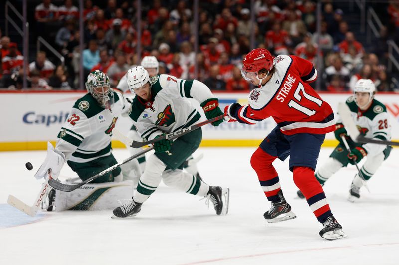 Oct 17, 2025; Washington, District of Columbia, USA; Washington Capitals center Dylan Strome (17) scores a goal on Minnesota Wild goaltender Filip Gustavsson (32) as Wild defenseman Brock Faber (7) defends during the third period at Capital One Arena. Mandatory Credit: Geoff Burke-Imagn Images