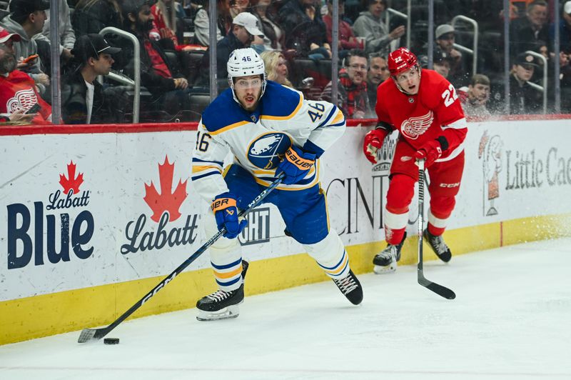 Apr 6, 2023; Detroit, Michigan, USA; Buffalo Sabres defenseman Ilya Lyubushkin (46) moves the puck ahead of Detroit Red Wings right wing Matt Luff (22) during the game at Little Caesars Arena. Mandatory Credit: Tim Fuller-USA TODAY Sports